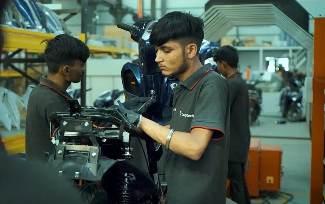 Comptech technicians working on an electric scooter
